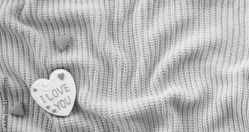 White Handmade Gingerbread with the Inscription I love you on a Sweater Background. Love Declaration. Place for the text. Valentine Wide Wallpaper photo