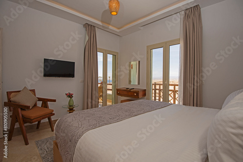Interior design of double bedroom in house with balcony