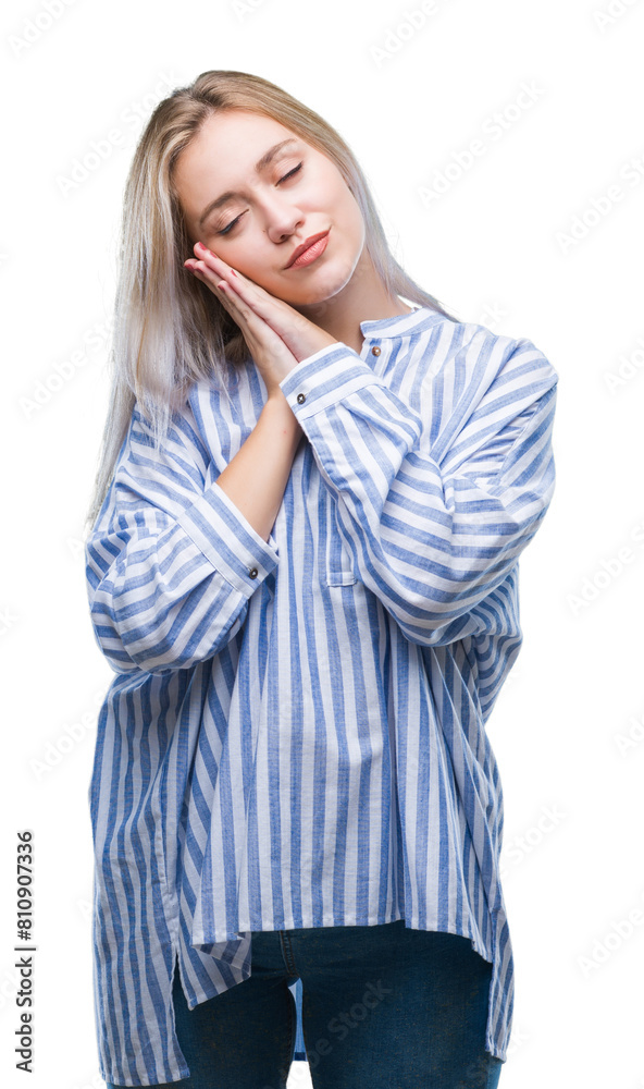Young blonde woman over isolated background sleeping tired dreaming and posing with hands together while smiling with closed eyes. Young blonde woman over isolated background sleeping tired dreaming and posing with hands together while smiling with closed eyes.