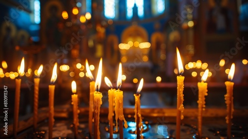 Many burning wax candles in the orthodox church or temple photo