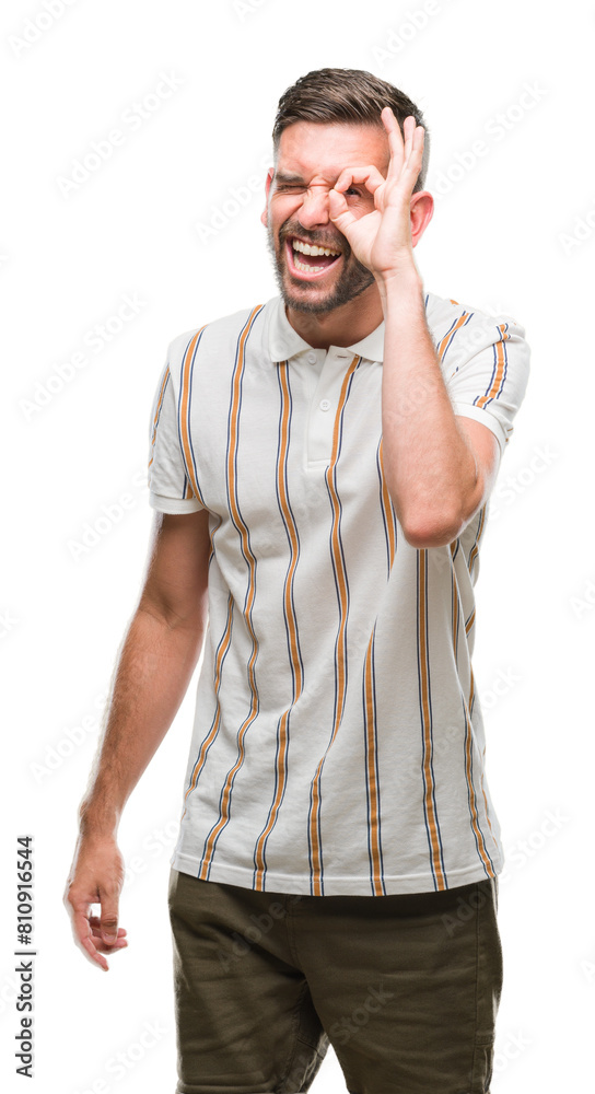 Young handsome man over isolated background doing ok gesture with hand smiling, eye looking through fingers with happy face. Young handsome man over isolated background doing ok gesture with hand smiling, eye looking through fingers with happy face.