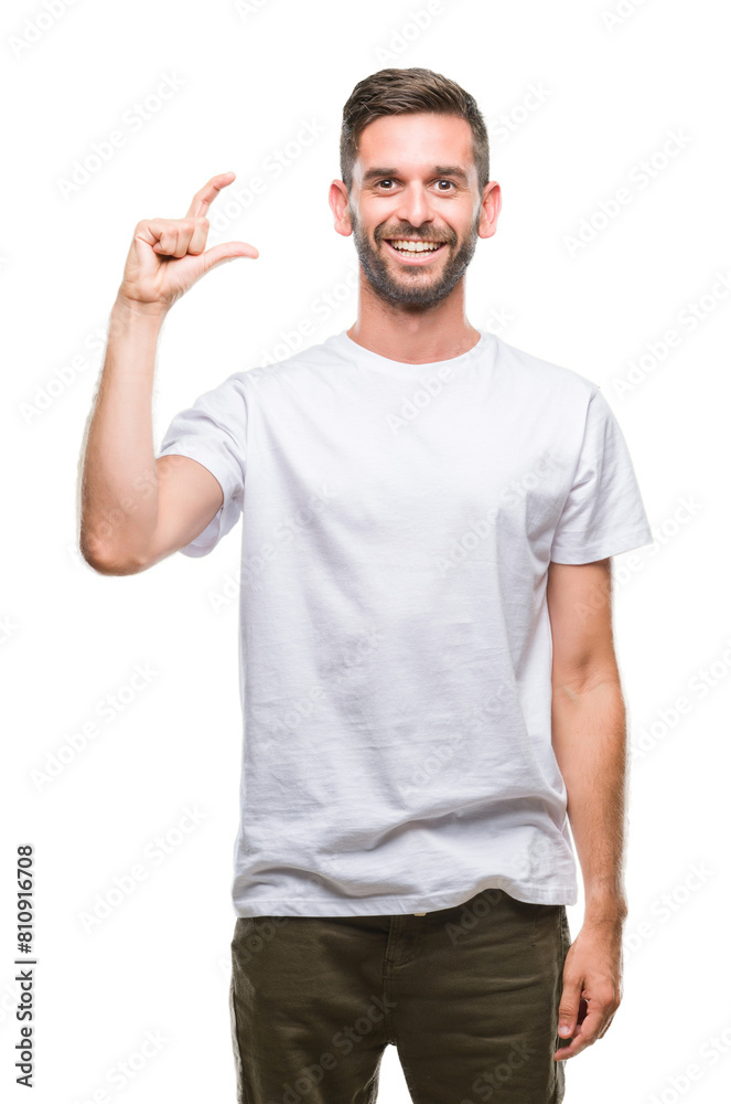 Young handsome man over isolated background smiling and confident gesturing with hand doing size sign with fingers while looking and the camera. Measure concept. Young handsome man over isolated background smiling and confident gesturing with hand doing size sign with fingers while looking and the camera. Measure concept.
