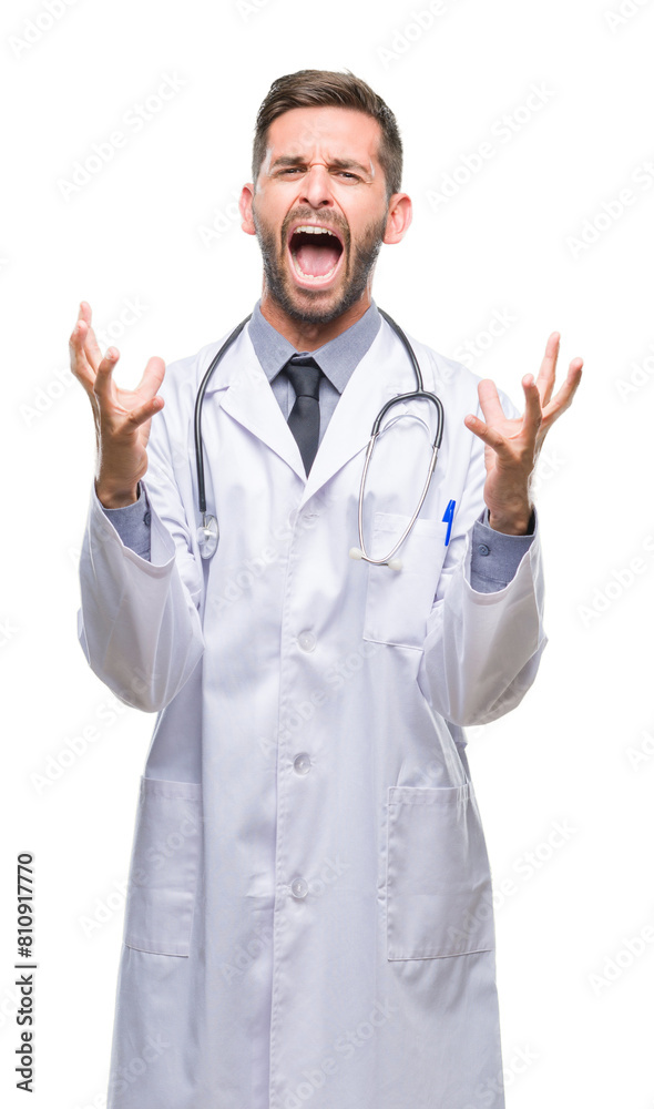 Young handsome doctor man over isolated background crazy and mad shouting and yelling with aggressive expression and arms raised. Frustration concept. Young handsome doctor man over isolated background crazy and mad shouting and yelling with aggressive expression and arms raised. Frustration concept.