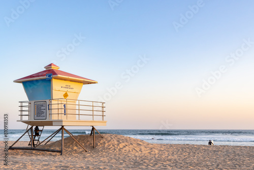 Overview of Beach in Pastel Colors with Lifeguard Tower in Midground  Waves and Clear Sky in Background  California  USA  horizontal-distant people