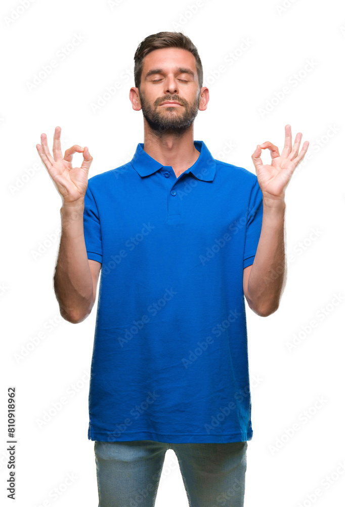 Young handsome man over isolated background relax and smiling with eyes closed doing meditation gesture with fingers. Yoga concept.