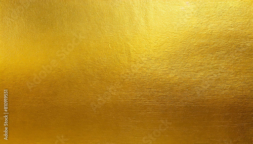 Gold wall texture background. Yellow shiny gold foil paint on wall sheet with gloss light reflection, vibrant golden paper luxury wallpaper