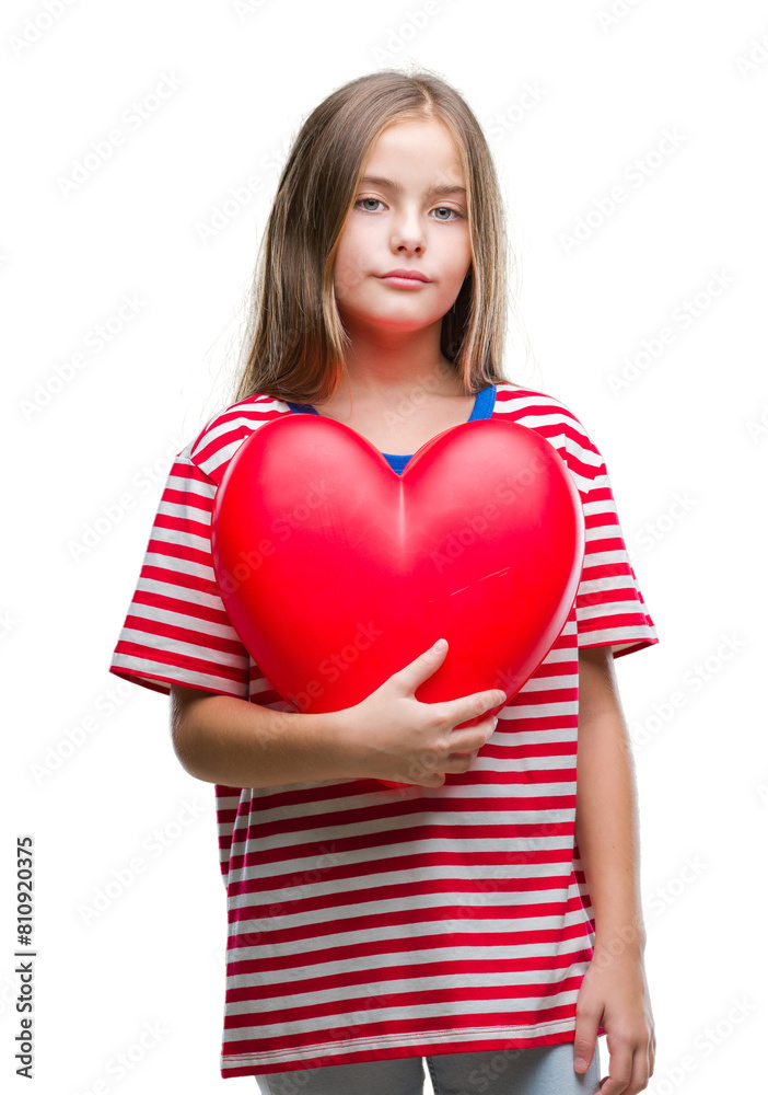 Young beautiful girl holding red heart over isolated background with a confident expression on smart face thinking serious Young beautiful girl holding red heart over isolated background with a confident expression on smart face thinking serious