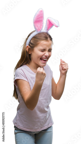 Canvas Print Young beautiful girl wearing easter bunny ears over isolated background very happy and excited doing winner gesture with arms raised, smiling and screaming for success