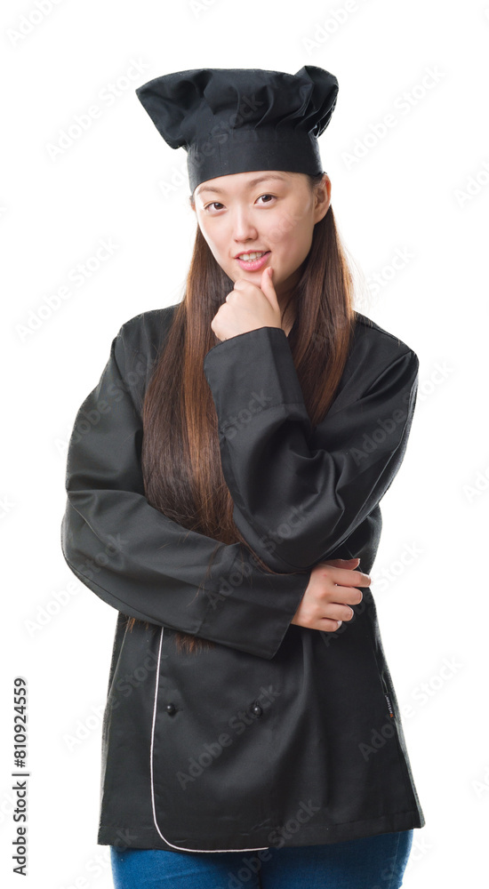 Young Chinese woman over isolated background wearing chef uniform looking confident at the camera with smile with crossed arms and hand raised on chin. Thinking positive. Young Chinese woman over isolated background wearing chef uniform looking confident at the camera with smile with crossed arms and hand raised on chin. Thinking positive.