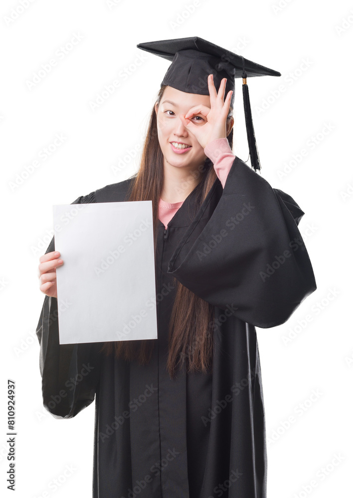 Young Chinese woman wearing graduate uniform holding paper degree with happy face smiling doing ok sign with hand on eye looking through fingers Young Chinese woman wearing graduate uniform holding paper degree with happy face smiling doing ok sign with hand on eye looking through fingers
