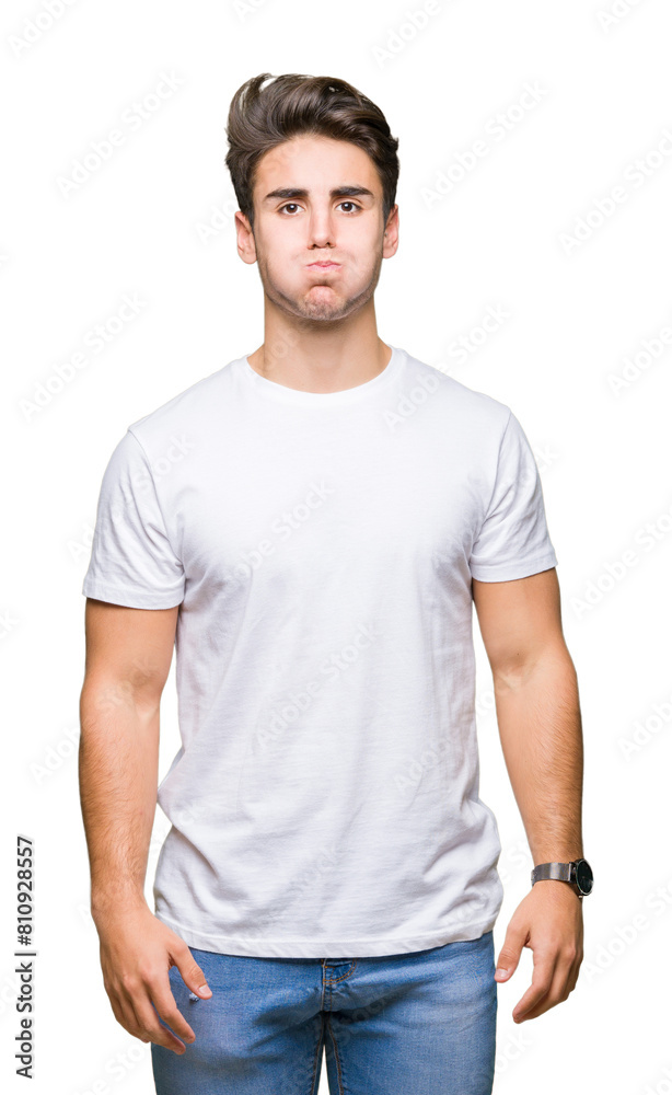 Young handsome man wearing white t-shirt over isolated background puffing cheeks with funny face. Mouth inflated with air, crazy expression. Young handsome man wearing white t-shirt over isolated background puffing cheeks with funny face. Mouth inflated with air, crazy expression.