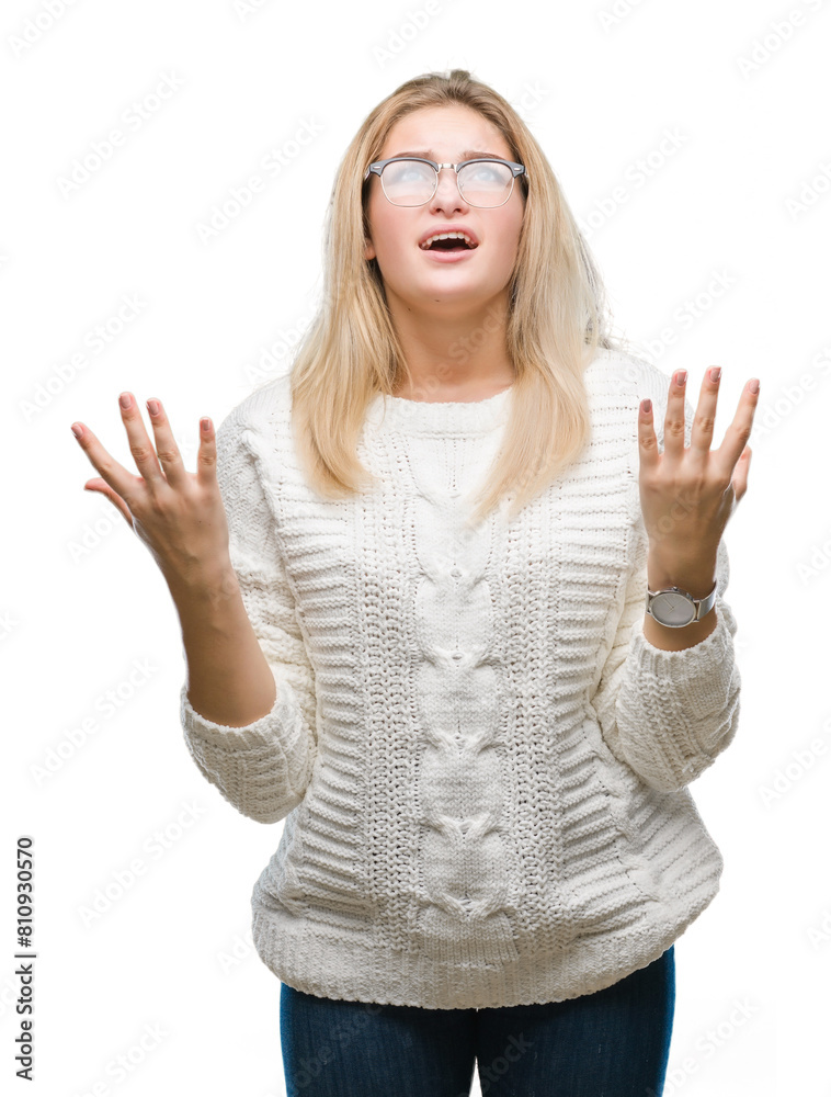 Fototapeta premium Young caucasian woman wearing glasses over isolated background crazy and mad shouting and yelling with aggressive expression and arms raised. Frustration concept.