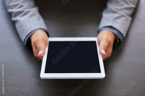 Business person, hands and tablet with screen for online browsing, news or research above at office. Closeup of employee with technology display or mockup space for innovation or productivity on desk