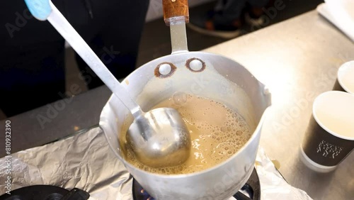 Chai Tea Masala Chai slow motion pouring in saucpan authentic asian