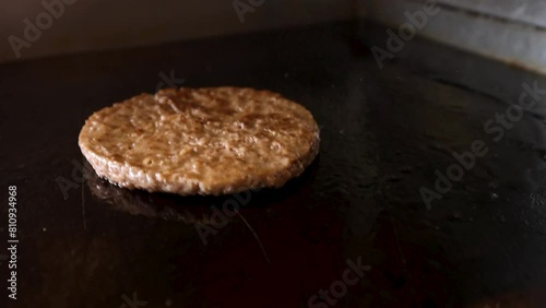 Burger flip in slow motion on a takeaway hotplate grill