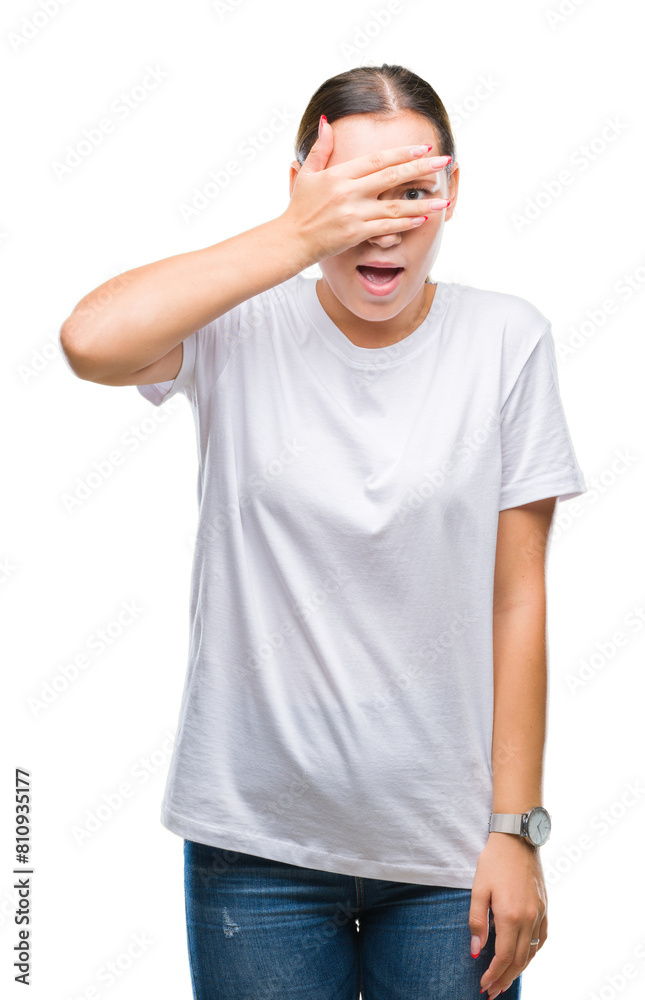 Young beautiful caucasian woman over isolated background peeking in shock covering face and eyes with hand, looking through fingers with embarrassed expression. Young beautiful caucasian woman over isolated background peeking in shock covering face and eyes with hand, looking through fingers with embarrassed expression.