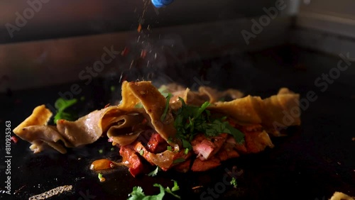 Doner meat with chicken tikka being cooked with sauces and seasoning