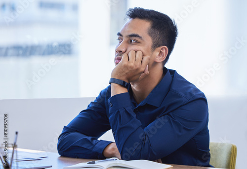 Business, man and thinking in office bored, desk and notebook for idea and vision for company or contemplating. Workplace, professional and distracted or daydreaming on job, employee and thoughtful