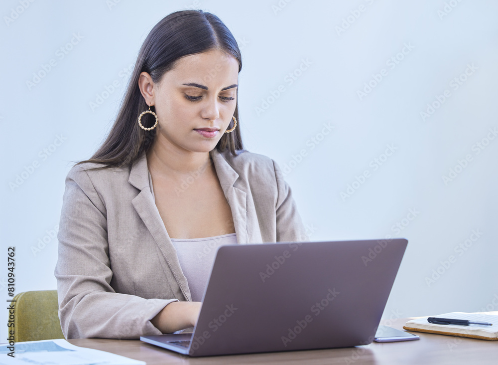 Laptop, typing and business woman reading email for project, research or communication online in office. Computer, serious and professional on website for planning, networking or agent writing report Laptop, typing and business woman reading email for project, research or communication online in office. Computer, serious and professional on website for planning, networking or agent writing report