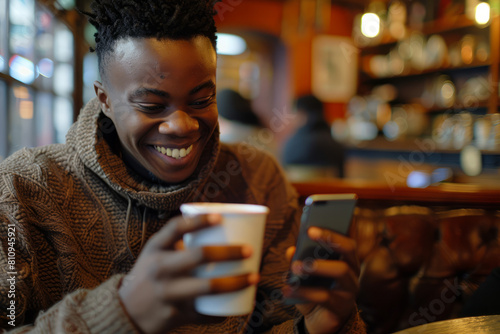 Amidst the cozy interior of a cafe  a young African American man indulges in a cup of coffee  his attention captured by his smartphone  a smile playing on his lips as he navigates through the digital