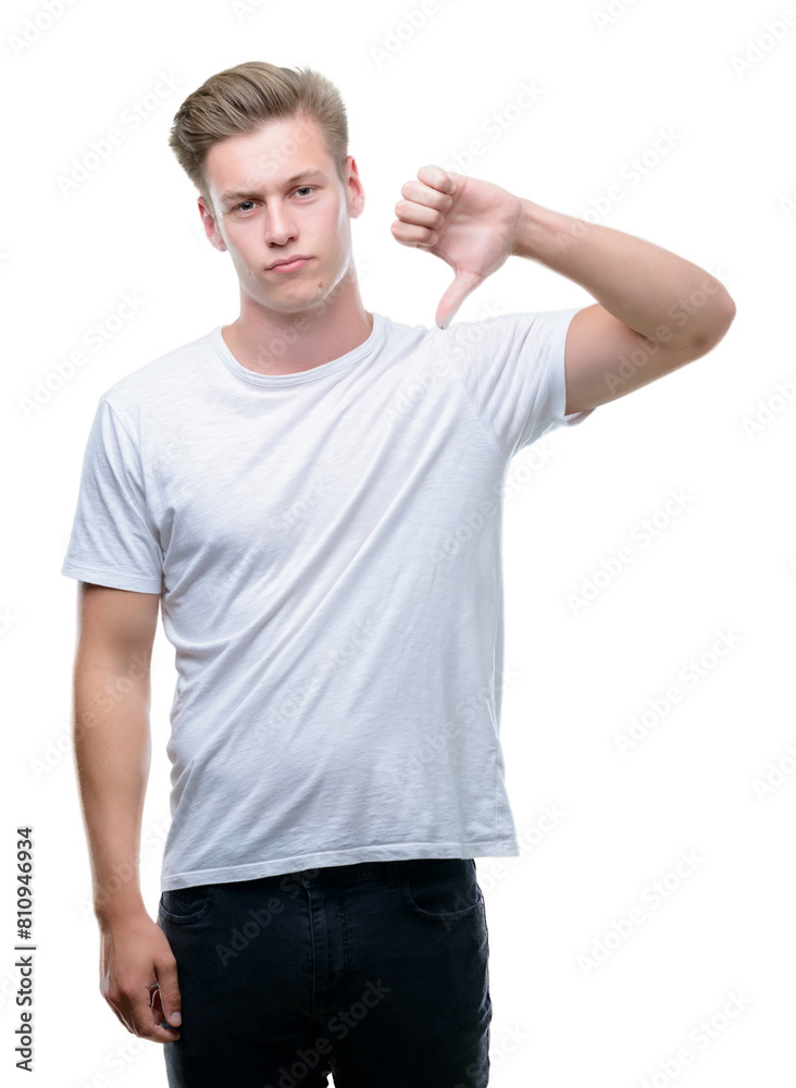 Young handsome blond man with angry face, negative sign showing dislike with thumbs down, rejection concept Young handsome blond man with angry face, negative sign showing dislike with thumbs down, rejection concept