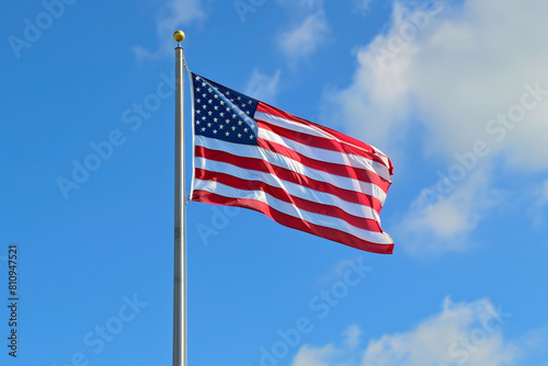 Sky blue backdrop enhances the American flag, offering Memorial Day celebration. photo