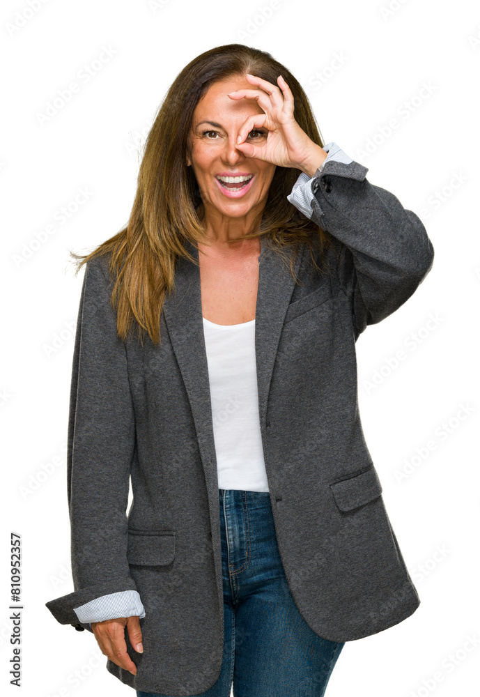 Middle age adult woman wearing oversize boyfriend jacket over isolated background doing ok gesture with hand smiling, eye looking through fingers with happy face. Middle age adult woman wearing oversize boyfriend jacket over isolated background doing ok gesture with hand smiling, eye looking through fingers with happy face.