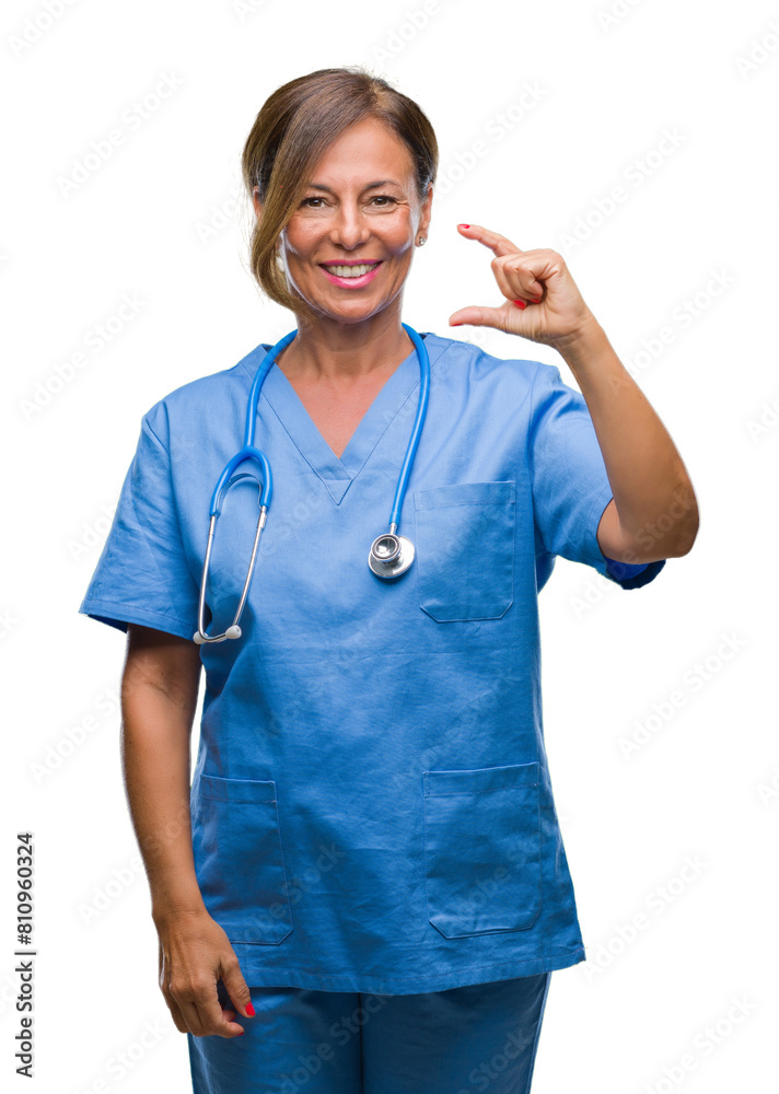 Middle age senior nurse doctor woman over isolated background smiling and confident gesturing with hand doing size sign with fingers while looking and the camera. Measure concept. Middle age senior nurse doctor woman over isolated background smiling and confident gesturing with hand doing size sign with fingers while looking and the camera. Measure concept.