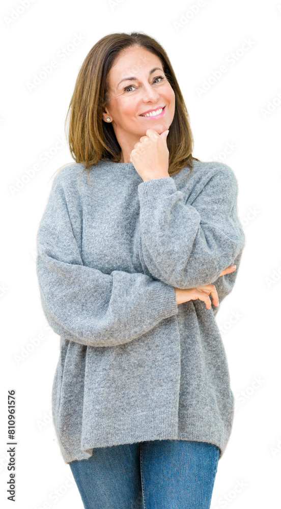 Beautiful middle age woman wearing winter sweater over isolated background looking confident at the camera with smile with crossed arms and hand raised on chin. Thinking positive. Beautiful middle age woman wearing winter sweater over isolated background looking confident at the camera with smile with crossed arms and hand raised on chin. Thinking positive.