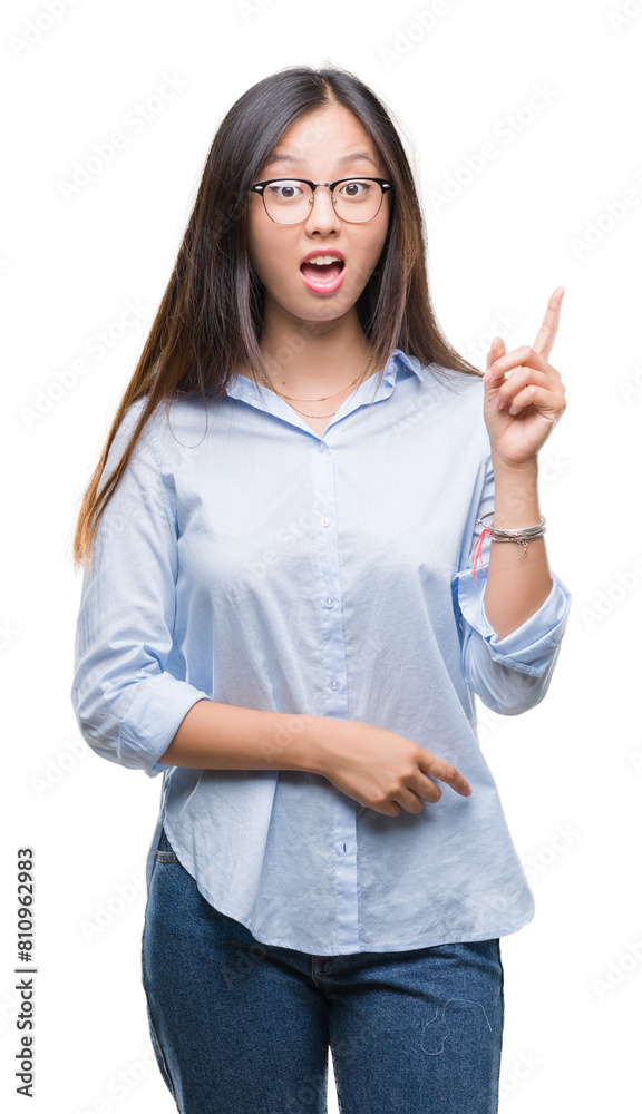 Young asian business woman wearing glasses over isolated background pointing finger up with successful idea. Exited and happy. Number one. Young asian business woman wearing glasses over isolated background pointing finger up with successful idea. Exited and happy. Number one.