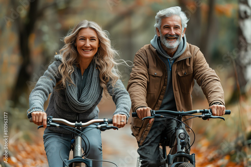 Happy active couple in their 60s riding bicycles