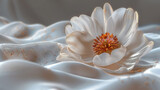   Large white flower on white fabric with golden flecks and sprinkles