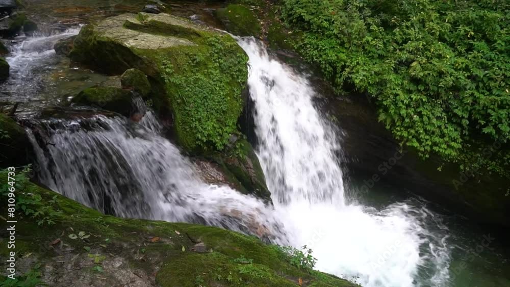 Beautiful waterfall on the way trekking to Annapurna base camp ABC - green natural scene at annapurna national park Nepal - footage 4K