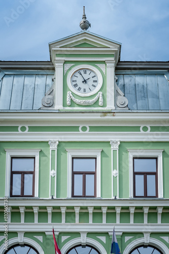 A fragment of the Kokmuiza manor with the decorated rooftop and the clock with numerals. Latvia, Baltic.