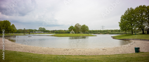 Small beach wide angle panorama landscape of recreational pond Lageveld in Wierden with picnic field and leisure area photo