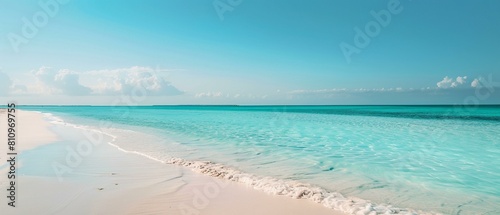 A wide shot of a tranquil beach with fine white sand