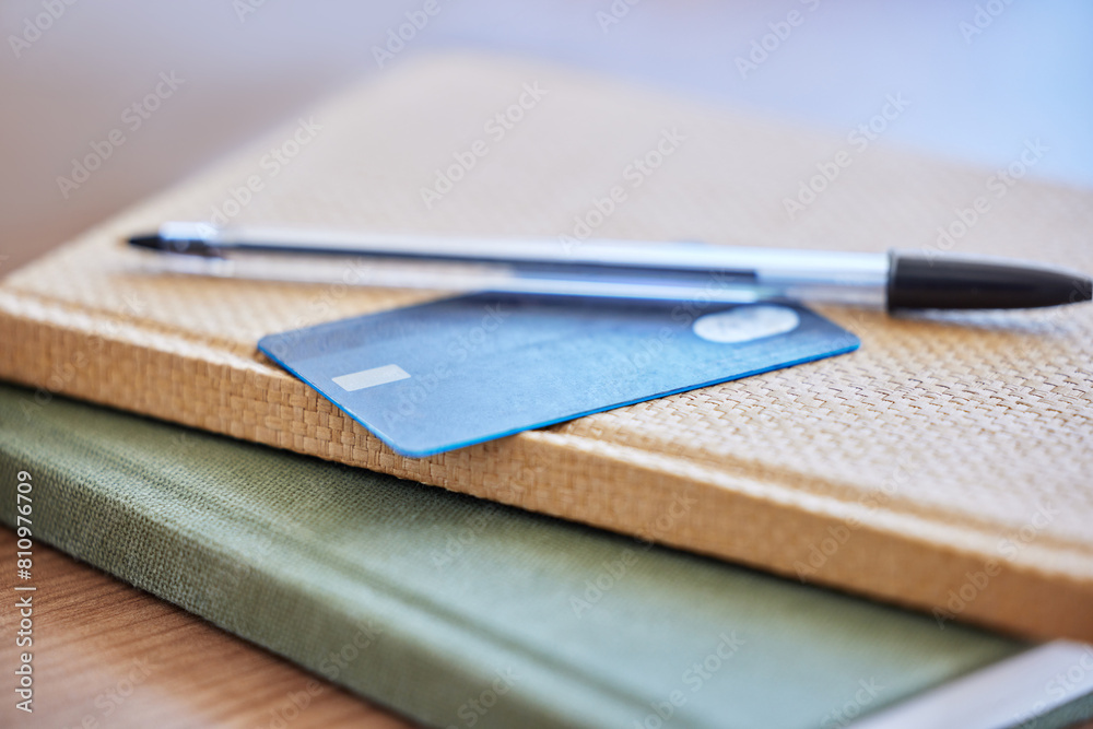 Credit card, pen and books by desk for planning budget with tax bills, company debt and fees for online shopping. Stationery, payment and notebook in empty office for ecommerce and business invoice Credit card, pen and books by desk for planning budget with tax bills, company debt and fees for online shopping. Stationery, payment and notebook in empty office for ecommerce and business invoice