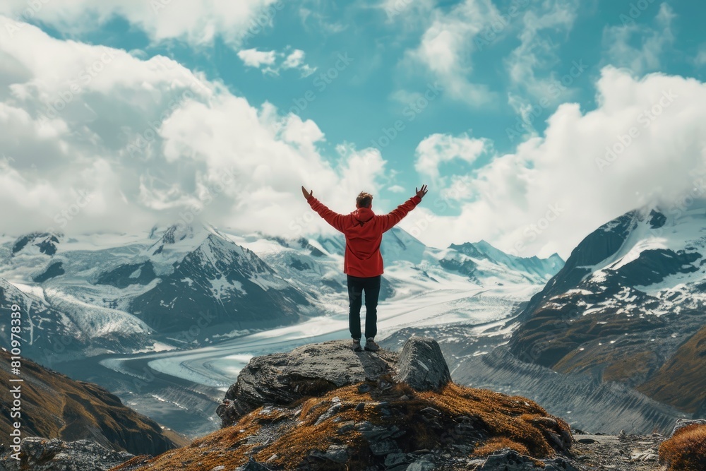 Man Standing on Mountain Summit With Arms Outstretched