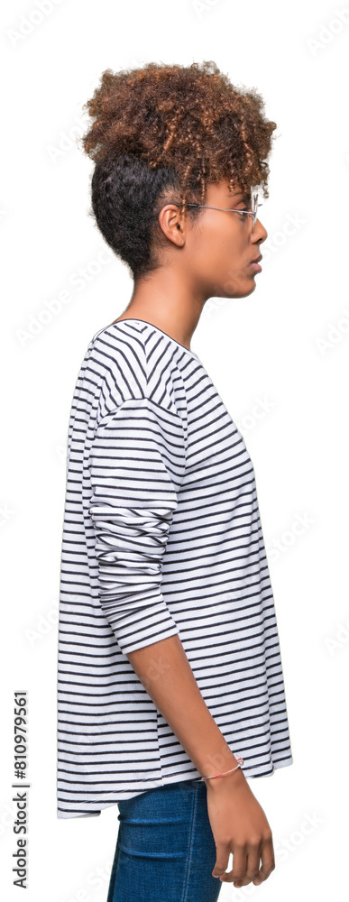 Beautiful young african american woman wearing glasses over isolated background looking to side, relax profile pose with natural face with confident smile. Beautiful young african american woman wearing glasses over isolated background looking to side, relax profile pose with natural face with confident smile.