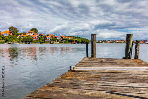 Scandinavian traditional houses and wooden jetty in Karlskrona on Baltic sea coast, Sweden.