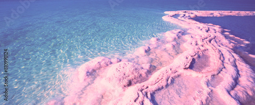 Texture of the Dead Sea in the pink light of the sunrise. Salty seashore. Abstract nature background