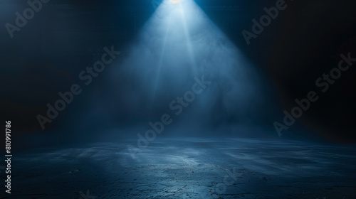 A dark room with a blue light shining on the floor. The room is empty and the light is the only source of illumination