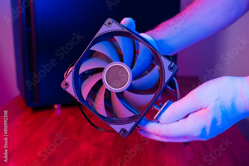Air cooling system with fan close up. PC case on background in neon light with smoke. Rendering and gaming computer hardware components. photo