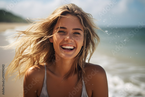 Yopung laughing blond woman having fun at beach