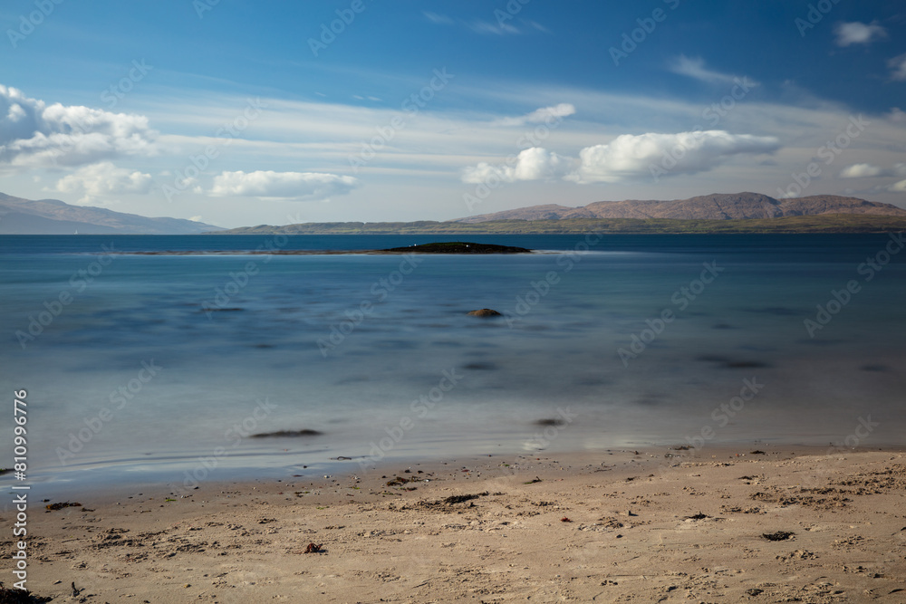 Sunny afternoon looking across Ganavan Bay with the Isle of Mull in the distance. Oban, Argyll and Bute, Scotland.
