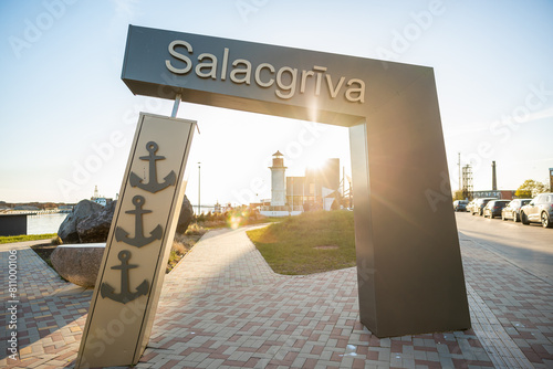 Welcoming entrance to Salacgriva in Latvia  with a decorative anchor sign and lighthouse in the background
