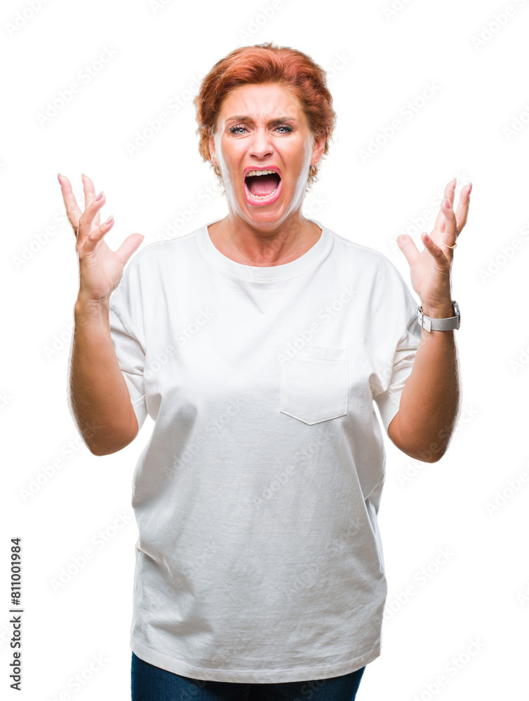 Atrractive senior caucasian redhead woman over isolated background crazy and mad shouting and yelling with aggressive expression and arms raised. Frustration concept. Atrractive senior caucasian redhead woman over isolated background crazy and mad shouting and yelling with aggressive expression and arms raised. Frustration concept.