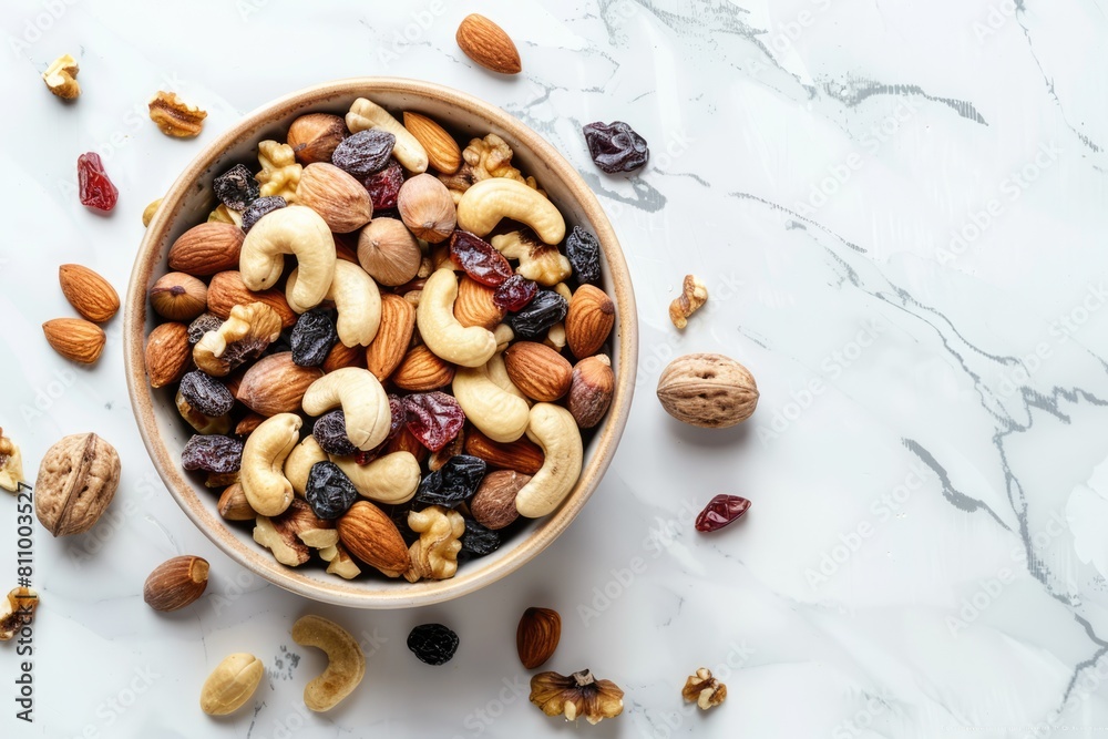 Top view of wooden bowl with nuts and dried fruit mix on dark wood board Top view of wooden bowl with nuts and dried fruit mix on dark wood board