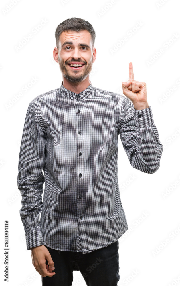 Young hipster man pointing finger up with successful idea. Exited and happy. Number one. Young hipster man pointing finger up with successful idea. Exited and happy. Number one.