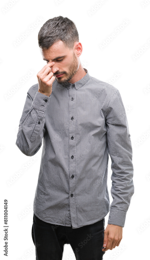 Young hipster man tired rubbing nose and eyes feeling fatigue and headache. Stress and frustration concept. Young hipster man tired rubbing nose and eyes feeling fatigue and headache. Stress and frustration concept.